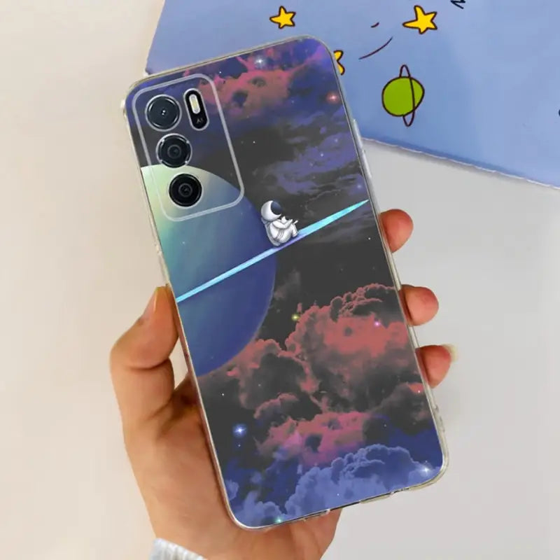 a hand holding a phone case with a space theme