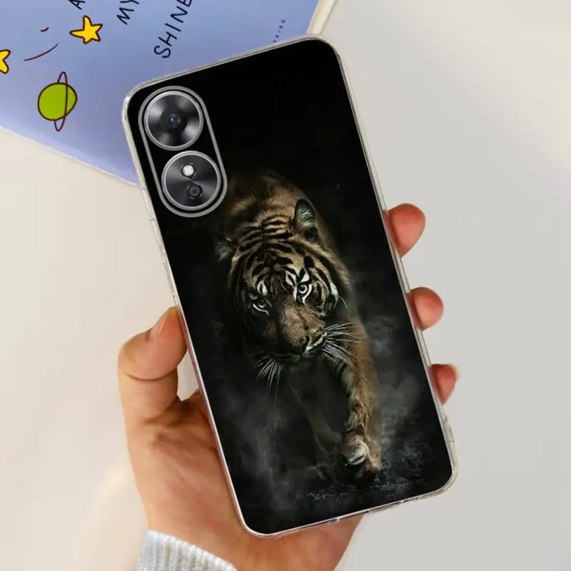 a person holding a phone case with a tiger on it