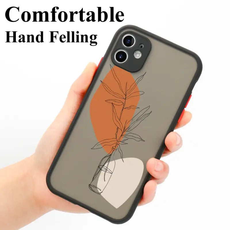 a hand holding a phone case with a plant on it