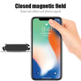 someone is holding a phone with a magnet in their hand