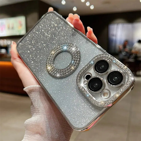 a woman holding a silver phone case with a ring