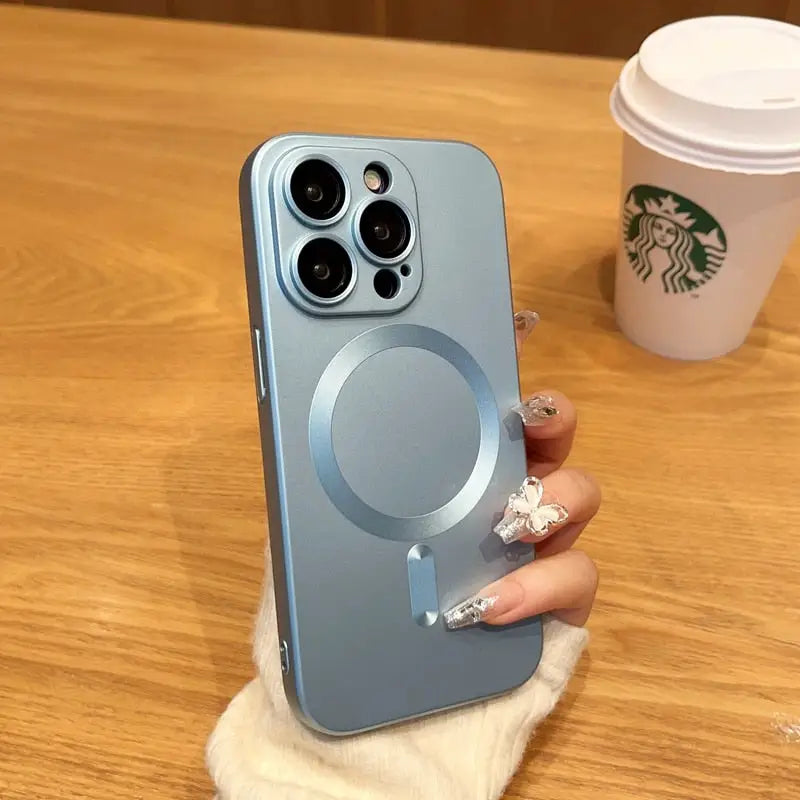 a woman holding a phone with a starbucks cup in the background