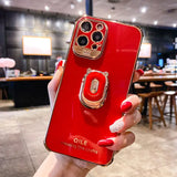 a woman holding a red phone case with a camera