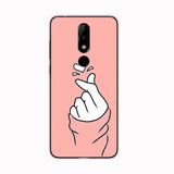 a pink phone case with a hand pointing at the camera