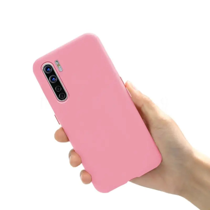 the pink iphone case is held up in a hand