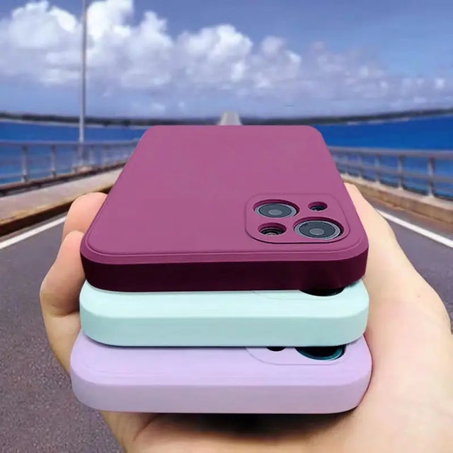 a hand holding a purple and blue case