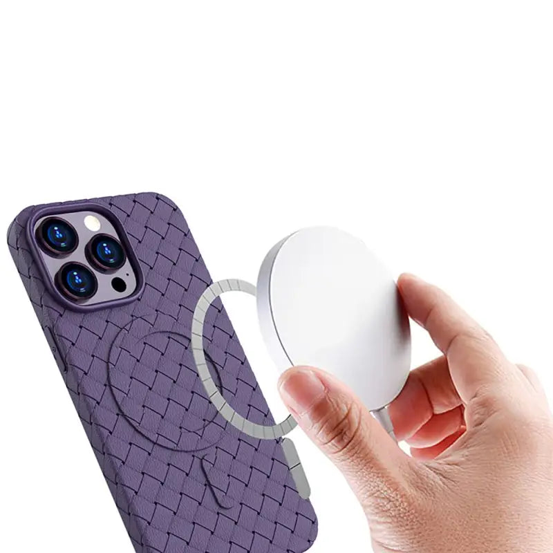 the back of a purple iphone case with a white button