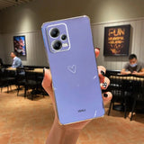 someone holding a purple phone with a heart on it