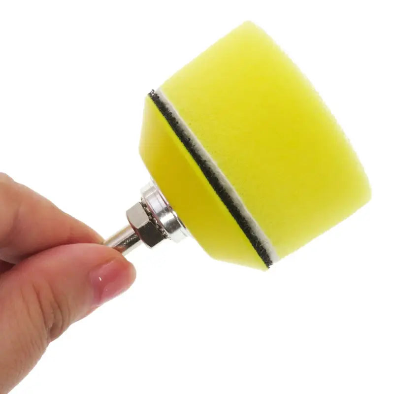 a hand holding a sponge with a sponge on it