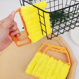 someone is holding a sponge brush and a sponge pad on a table