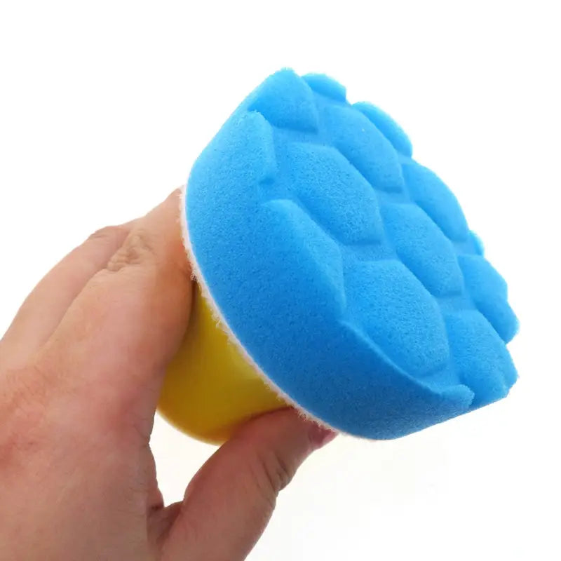 someone is holding a sponge in their hand on a white background