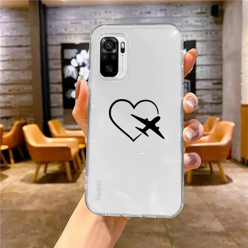 a hand holding a white phone case with a heart and an arrow