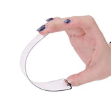 a hand holding a white paper ring