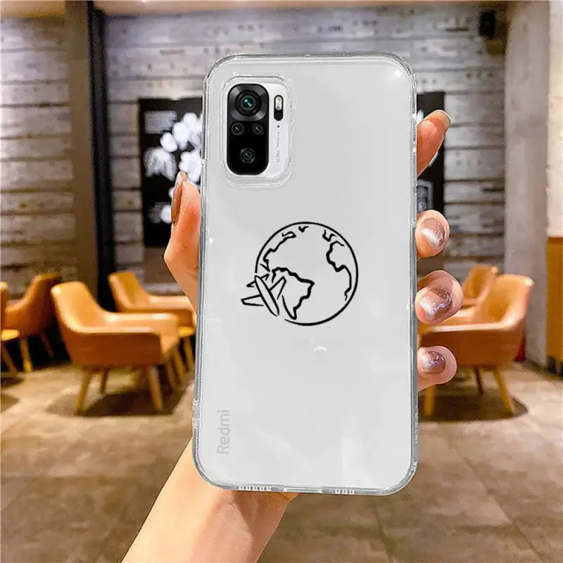 a hand holding a white phone case with a black earth logo