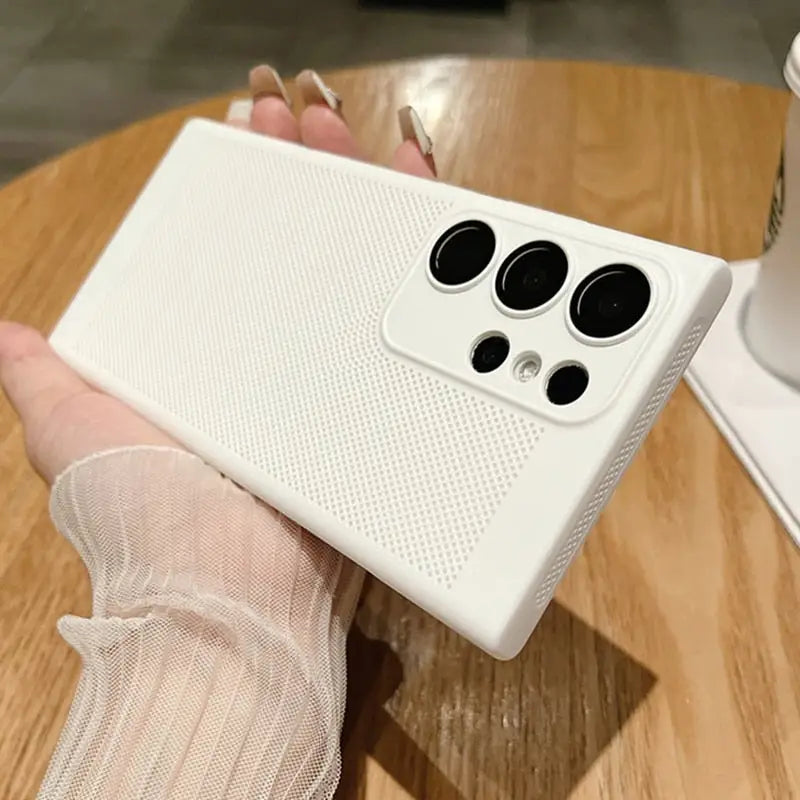 a person holding a white iphone case