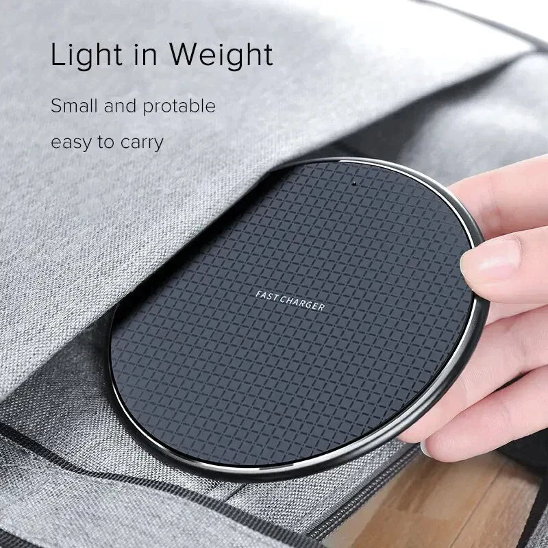 a hand holding a wireless charger in a gray bag