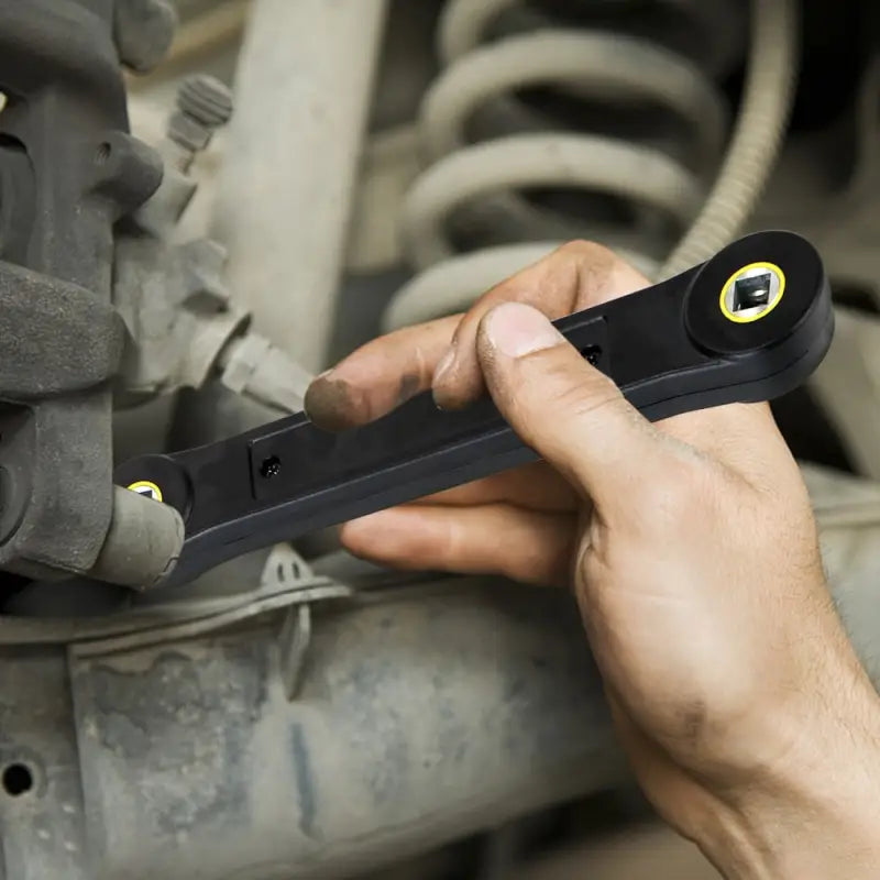 a man is working on a car’s engine