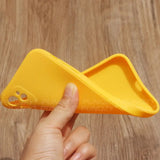 a hand holding a yellow plastic object