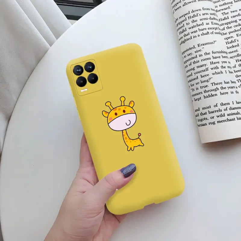 a person holding a yellow phone case with a cartoon gi