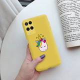 a hand holding a yellow phone case with a unicorn on it