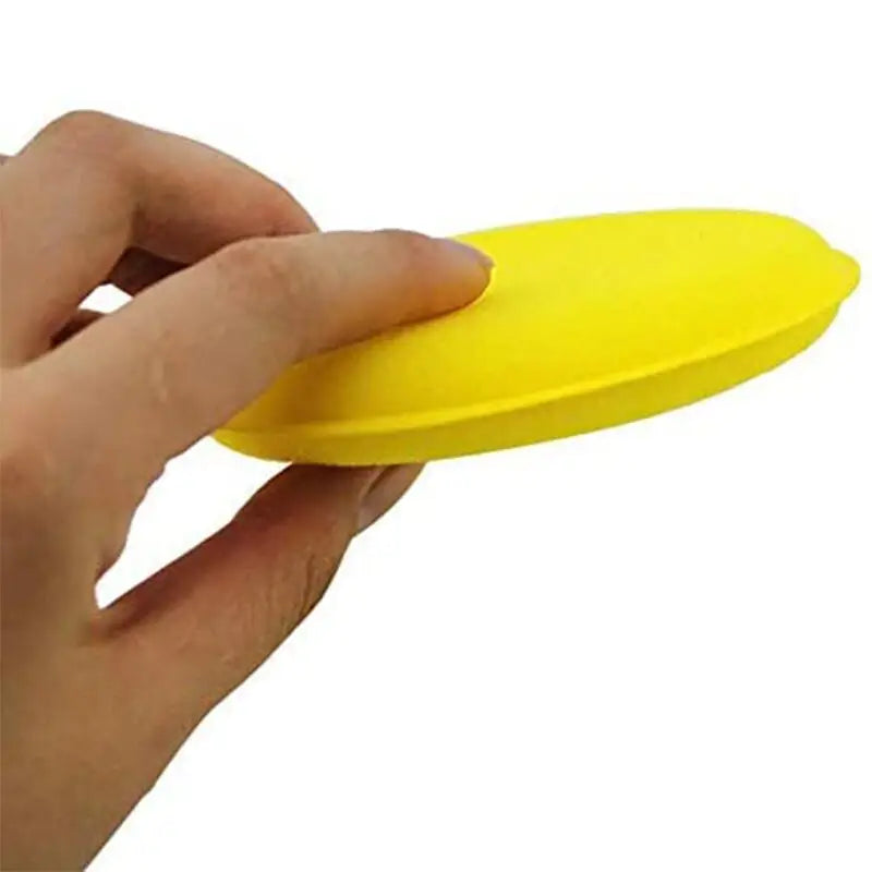 a hand holding a yellow object