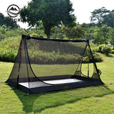 a black and white tent with a black net on the ground