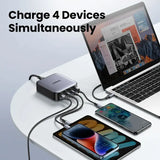 An image of a laptop, phone and charger on a table
