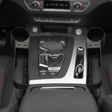 the interior of a car with a steering and a cup holder