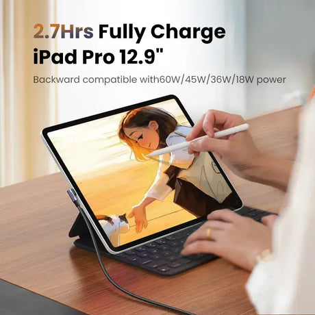 The ipad is sitting on a table with a person holding a pen