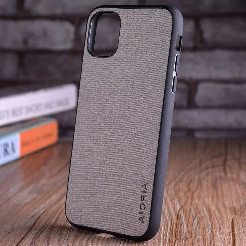 the iphone 11 case is made from a dark grey fabric