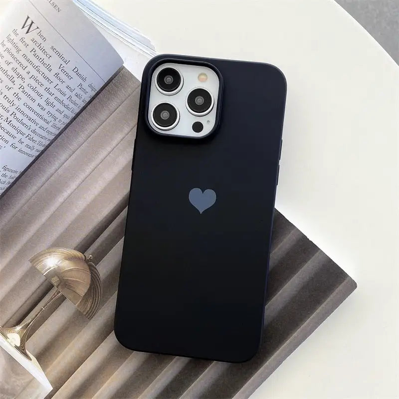 the iphone 11 pro case is shown on a table next to a book