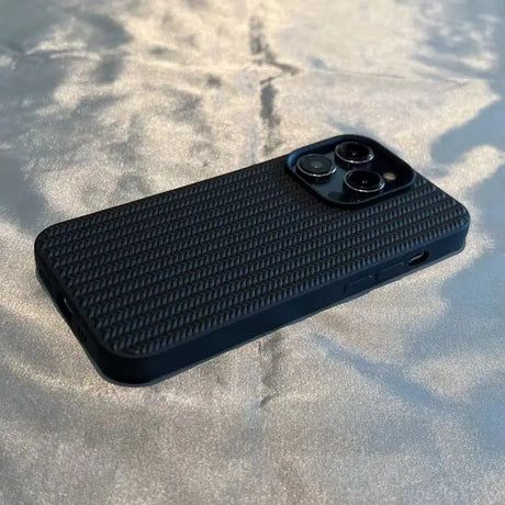 the back of a black iphone case on a table