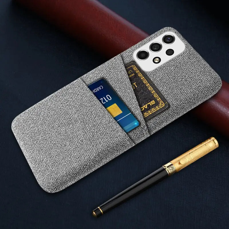 the iphone case is made from a tweed fabric and has a credit card slot