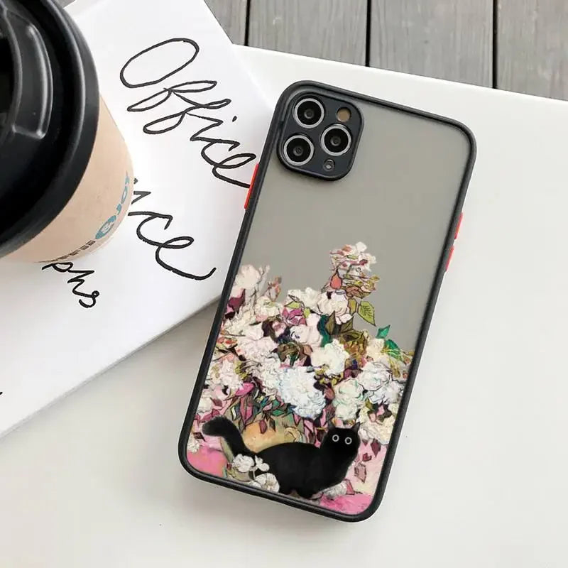 IPhone case with a floral design and a black cat illustration.