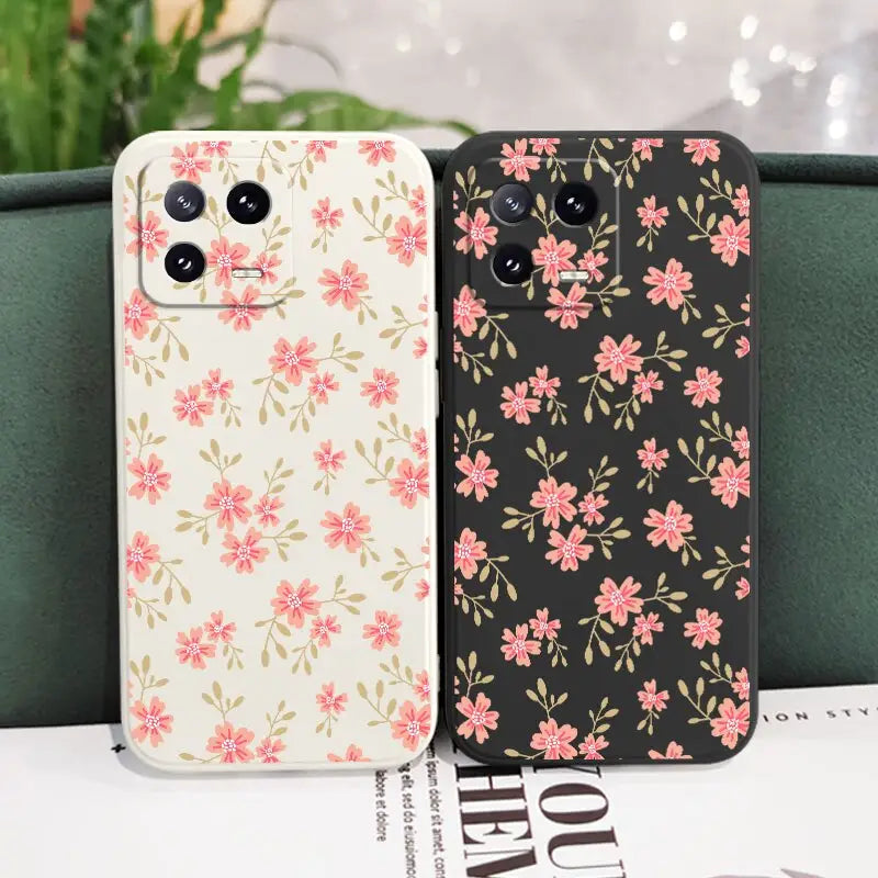 a pair of iphone cases with pink flowers on them