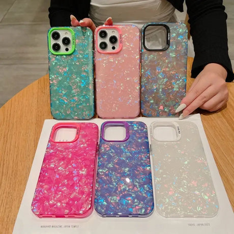 a woman holding a phone case with glitter