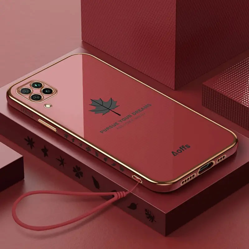 a red iphone case with a gold frame and a red phone case