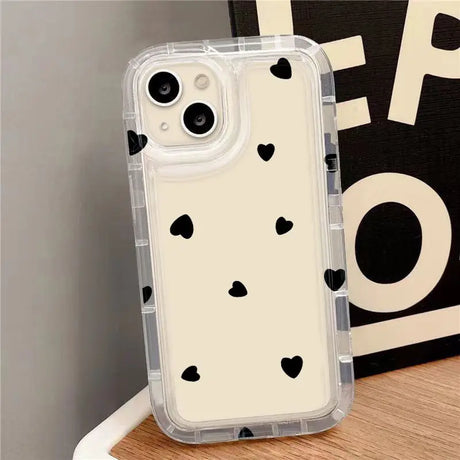 a white phone case with black hearts on it