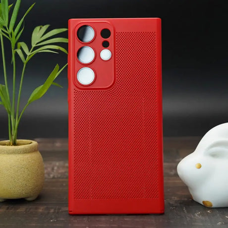 the red case is next to a plant