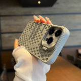 IPhone case with a honeycomb-like textured pattern and triple camera cutout.