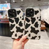 a pair of black and white cow print cases