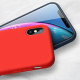the red iphone case is shown with the iphone x in the background