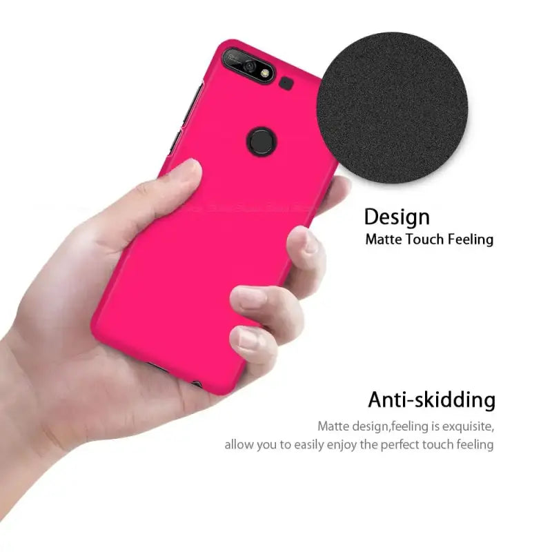the iphone case is pink with a black circle on it