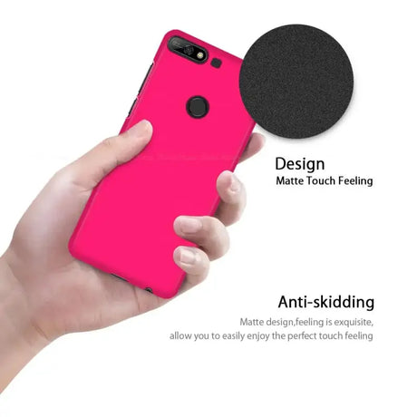 The iphone case is pink with a black circle on it