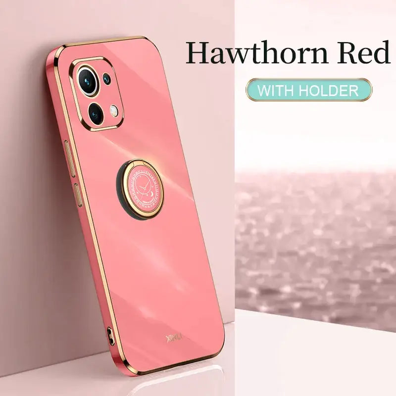 the iphone case is pink with gold trim