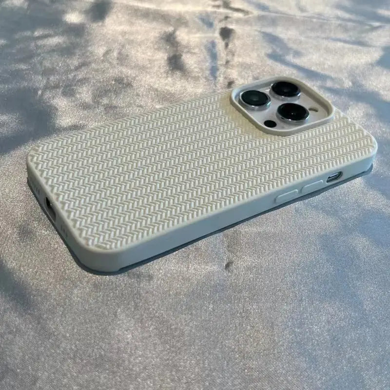 the back of a white iphone case on a concrete surface