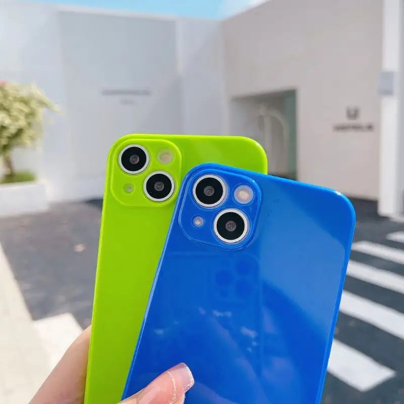 a person holding a blue and green iphone case