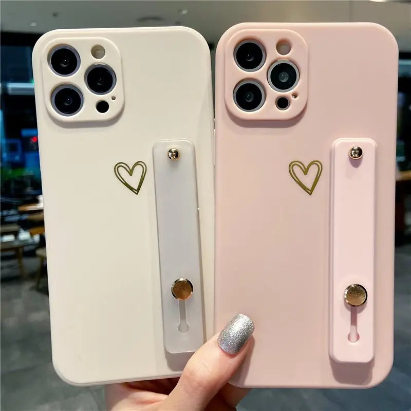 two iphone cases with heart shaped handles