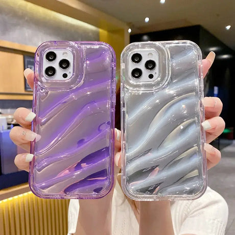 a woman holding two iphone cases in her hands