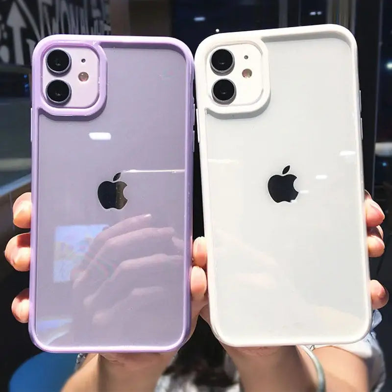 two people holding up their iphones